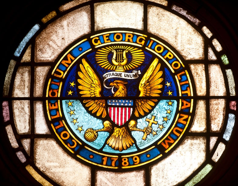 close-up of stained glass window of Georgetown University Seal