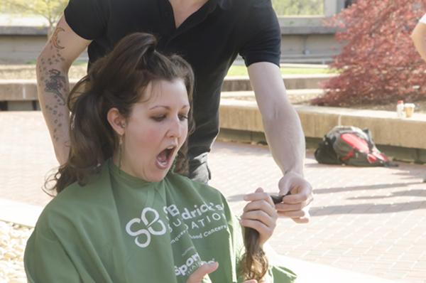 photo of women holding locks of hair from from St. Baldrick's Foundation event at SOM