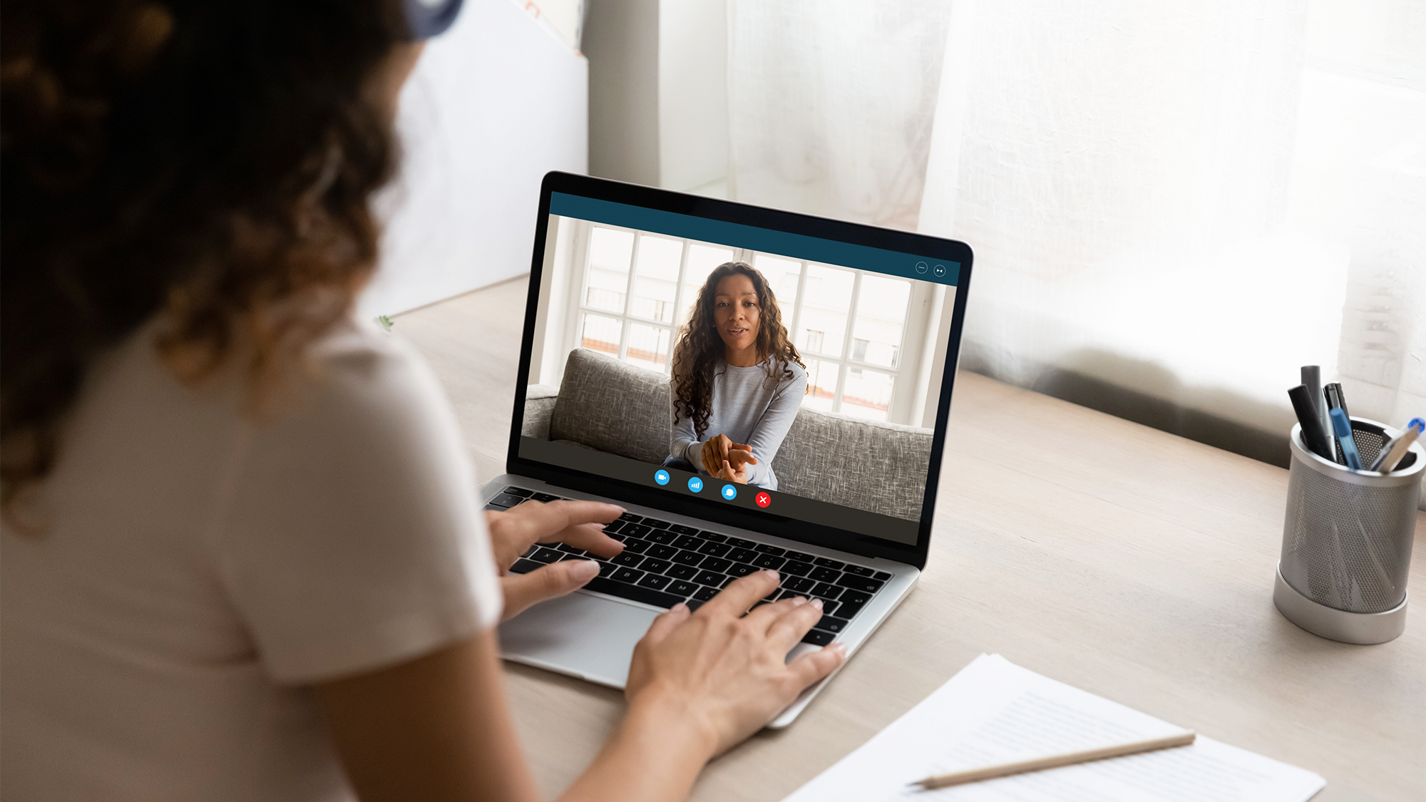 a student advises another student virtually via laptop