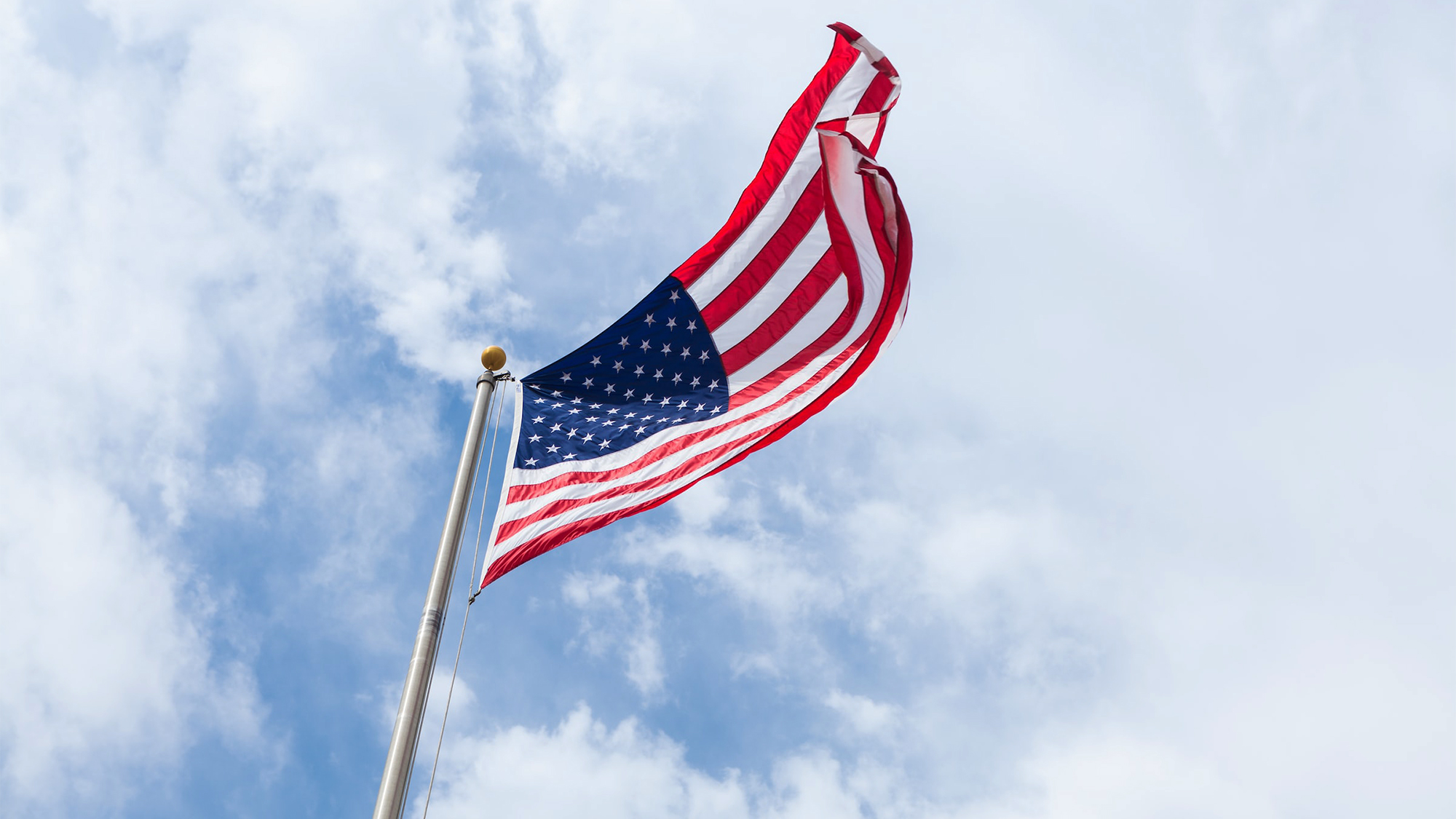 American flag on a pole against a blue sky