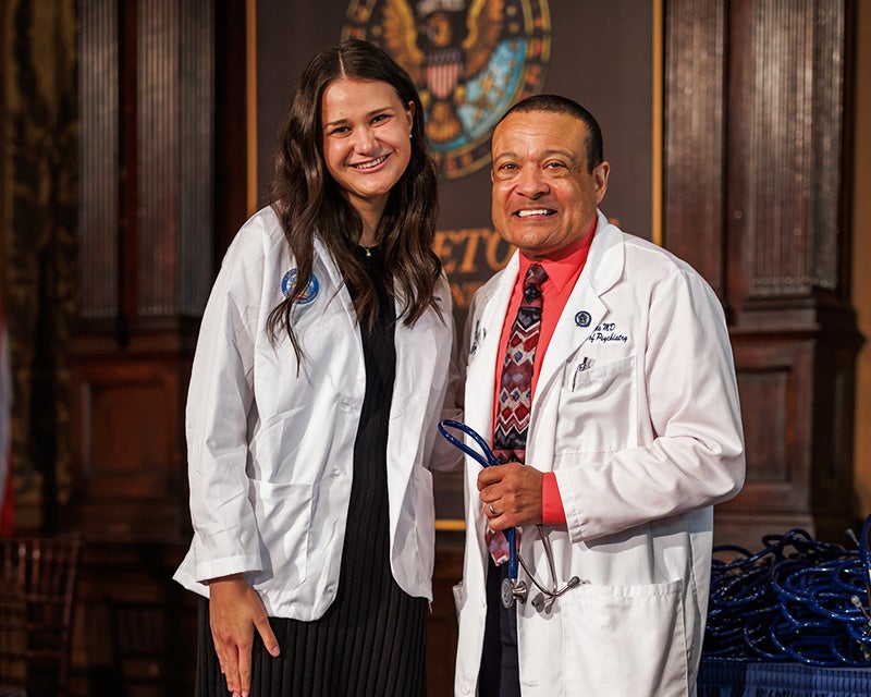 Alycia Cusson stands next to Dean Jones onstage