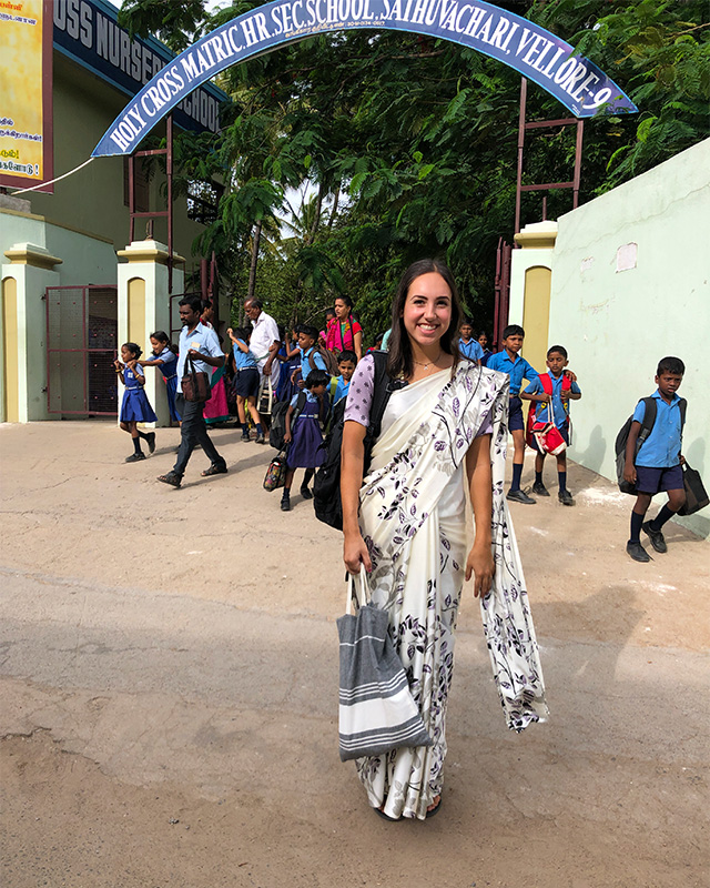 Amanda Wibben stands outside a school in India wearing a sari