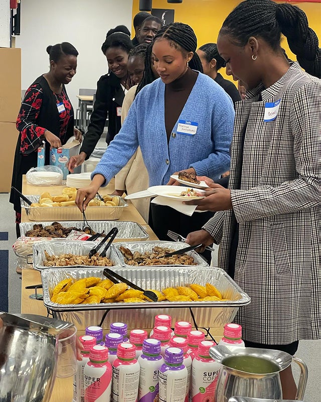 Students help themselves to food in a buffet line