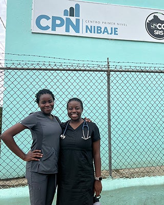 Students Phoebe Ato and Rukewe Kehinde stand next to each other