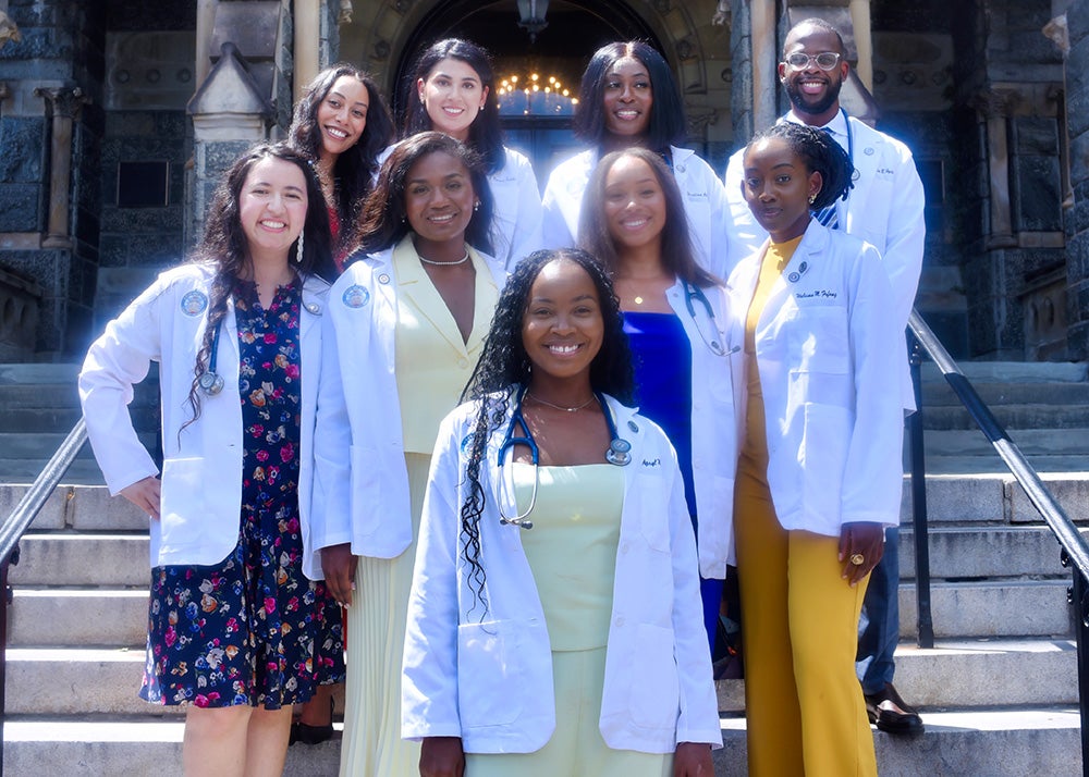 GEMS program graduates who are incoming into the School of Medicine stand together on the steps of Healy Hall