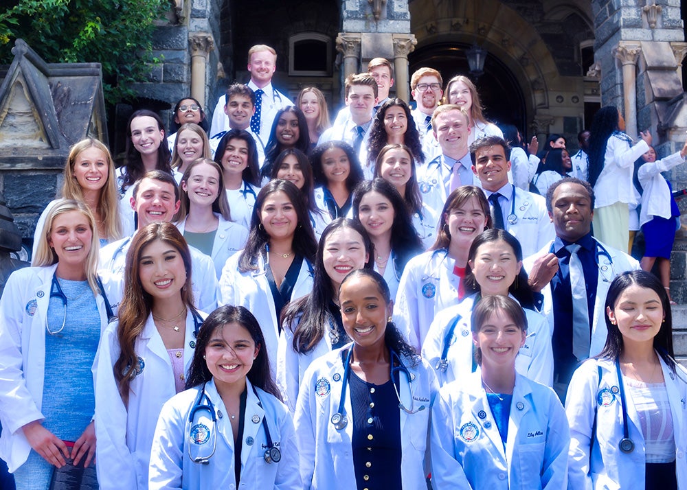 Physios who are incoming School of Medicine students stand together on the steps of Healy Hall