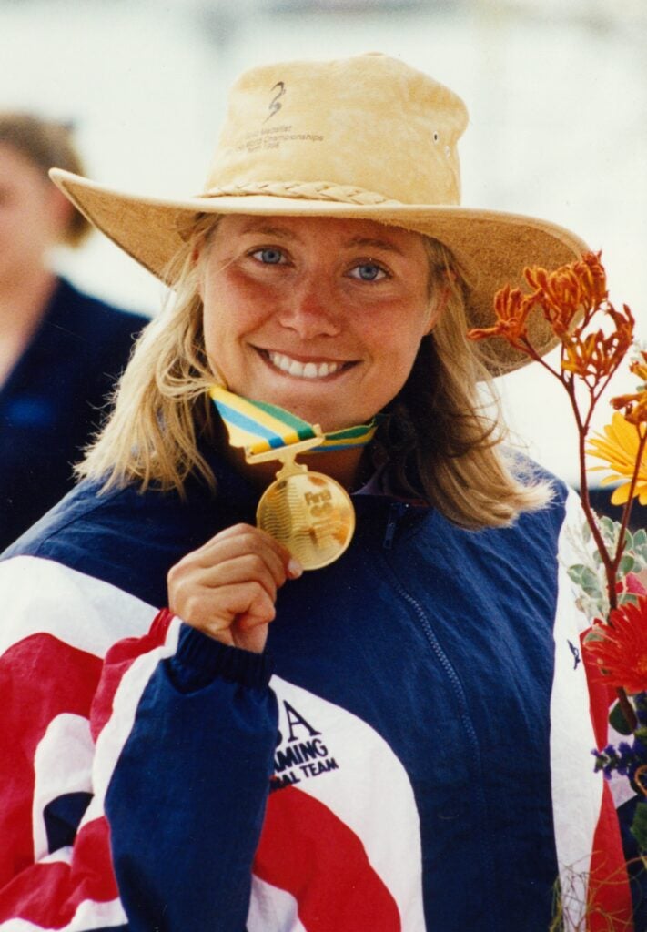 Smith holds a gold medal and smiles