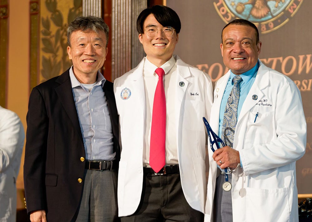 Yuki Cui is flanked by his father and Dr. Jones