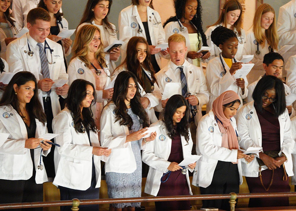 School of Medicine students stand in Gaston Hall and recite the Hippocratic Oath