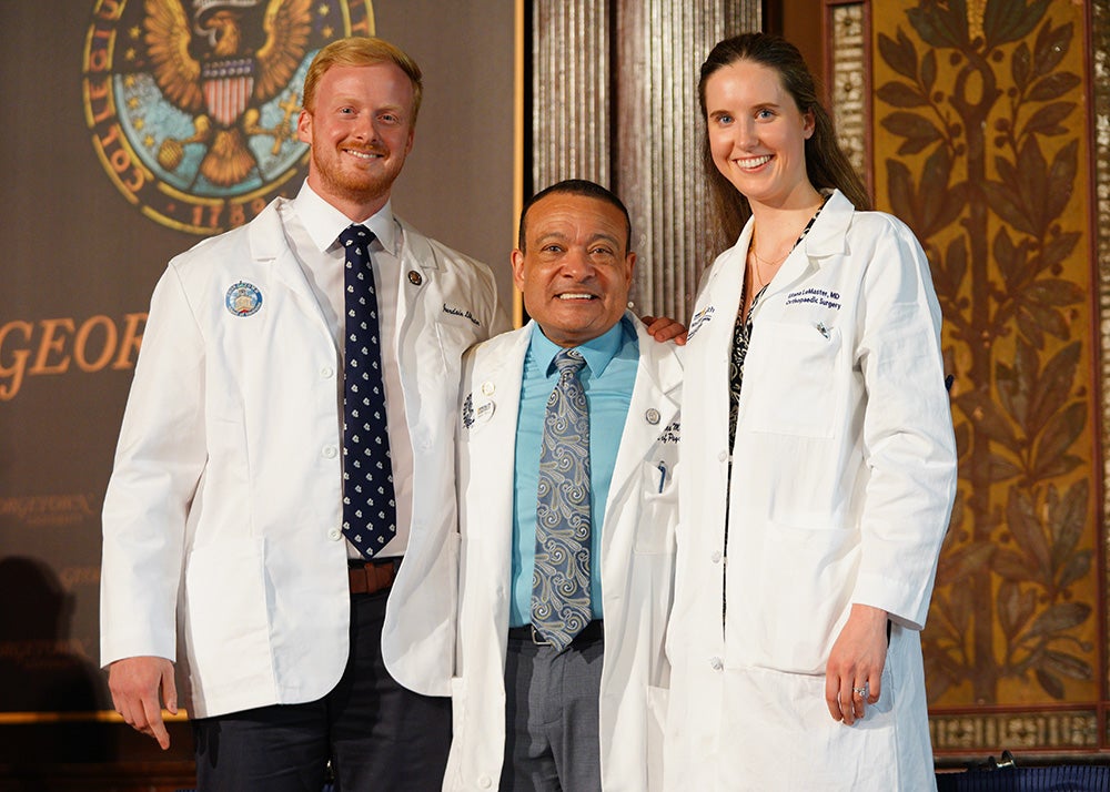 Jourdain LeMaster and his wife flank Dean Jones at the White Coat ceremony