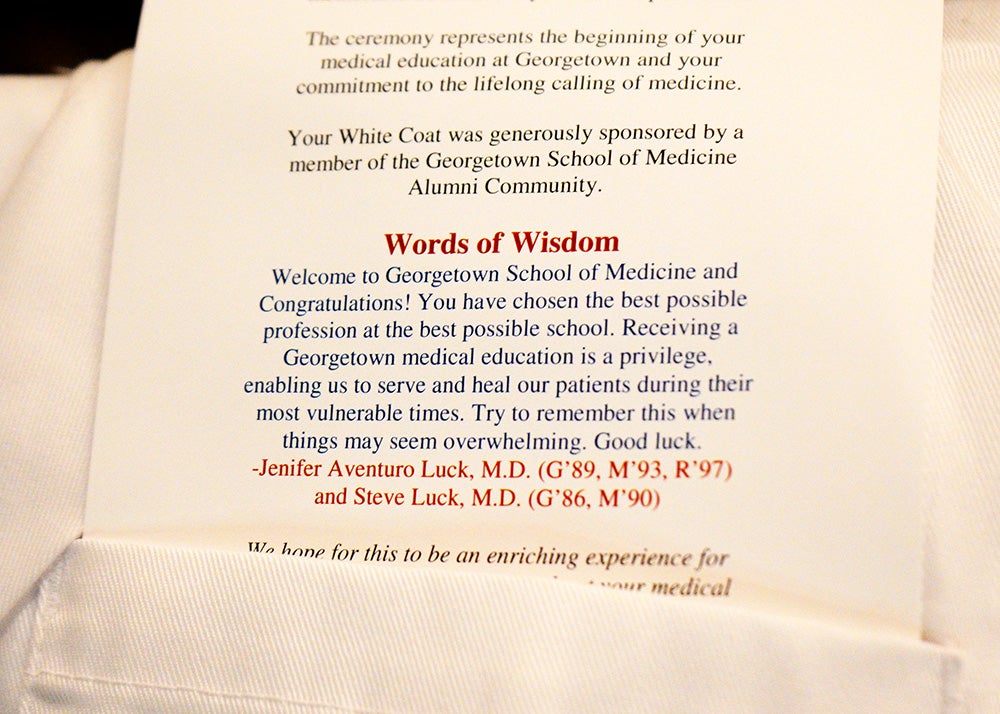 A message left in the pocket of a student's white coat with words of wisdom from Jenifer and Steve Luck, both alums