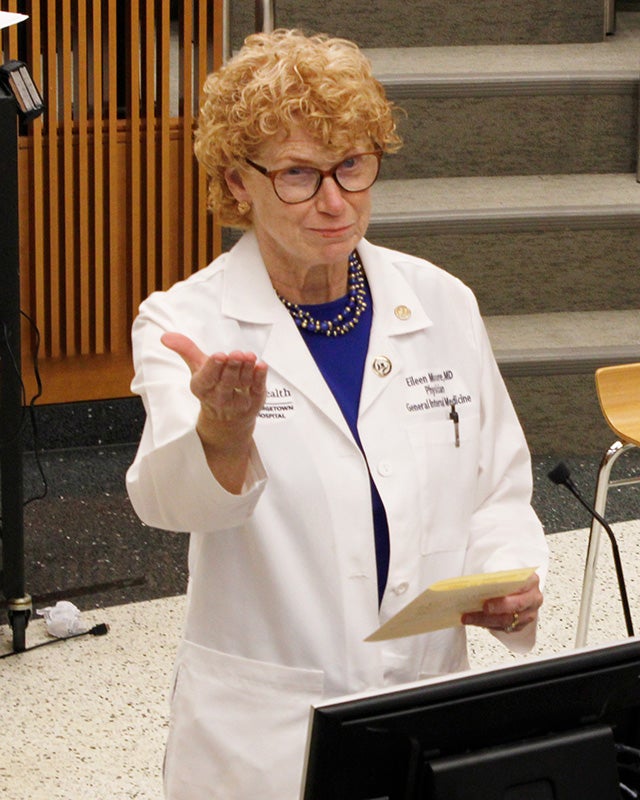 Eileen Moore speaks from a podium