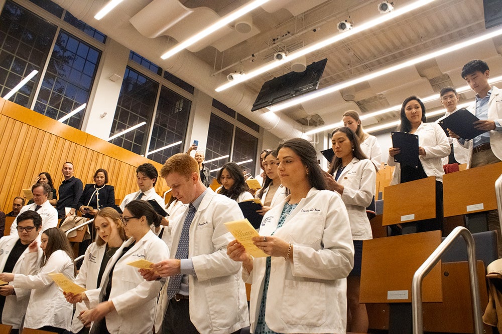 Students stood in their rows while speaking the oath of the Gold Humanism Honor Society