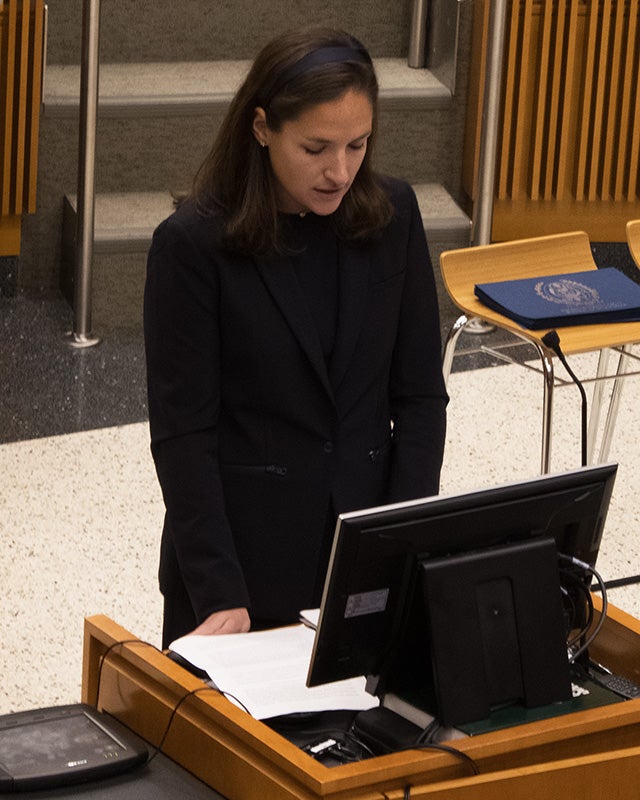 Alexandra O'Kane speaks from a podium