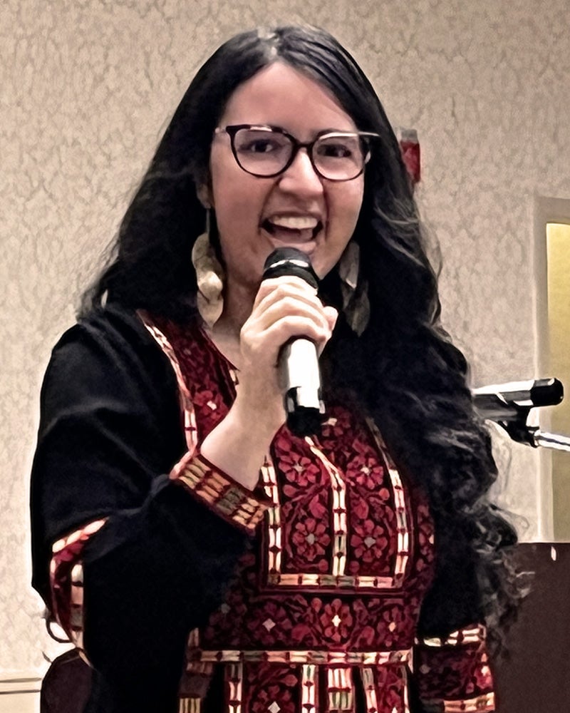 Julia Hakeem speaks at the Interfaith Dinner