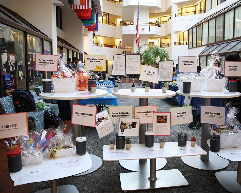 Raffle items are arrayed on small stands and tables