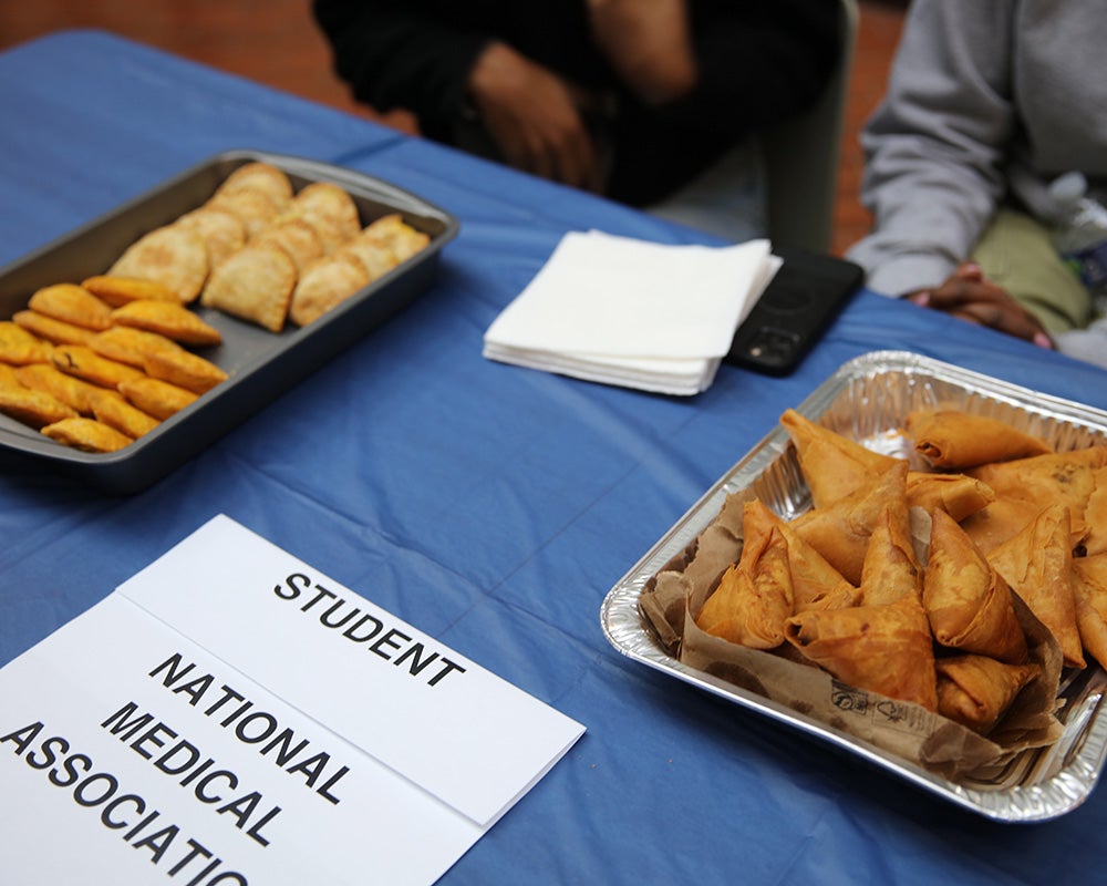 Food in foil dishes on a table for the Student National Medical Association