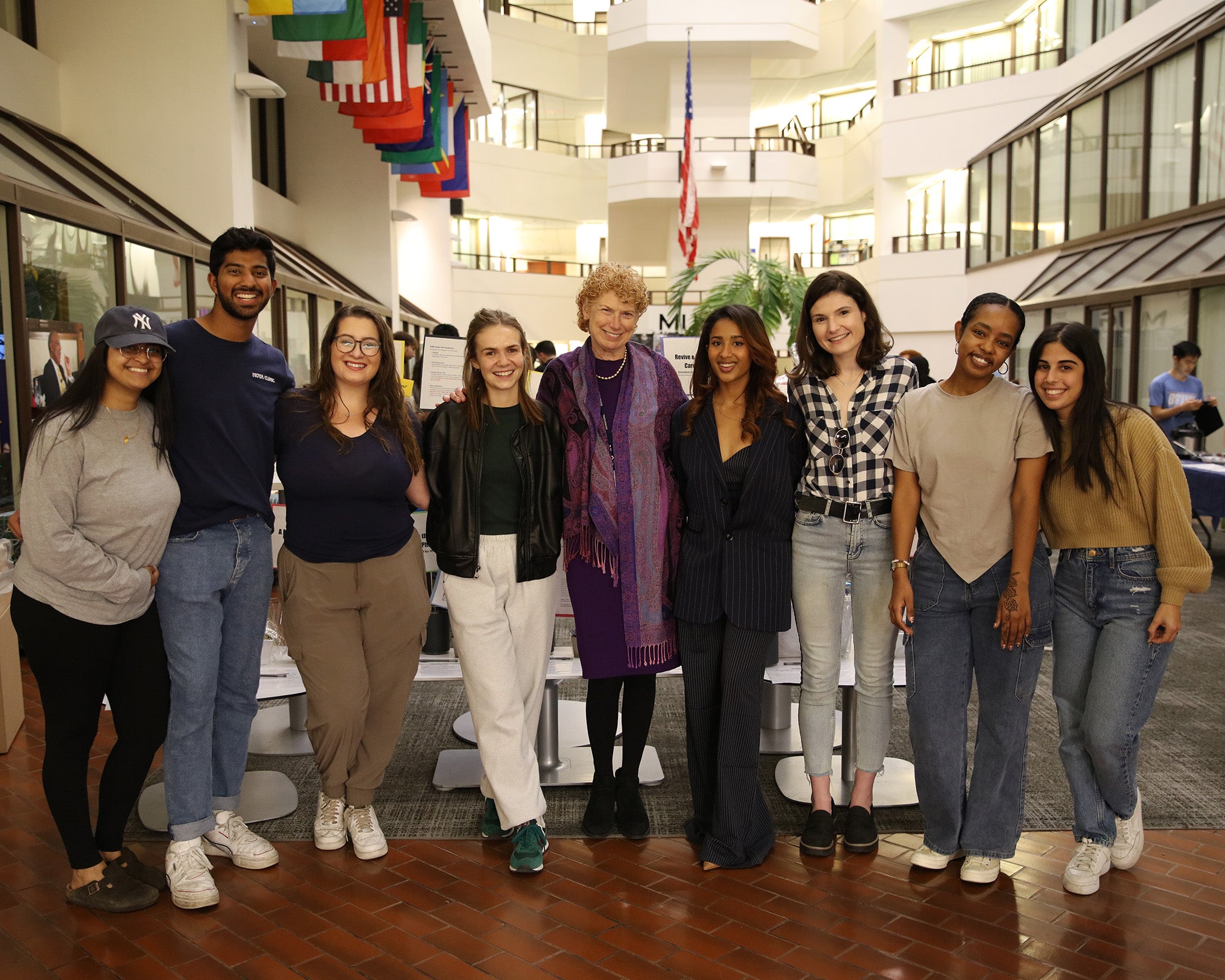 Nine people stand together in the ICC Galleria