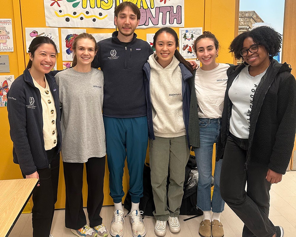 six students stand together